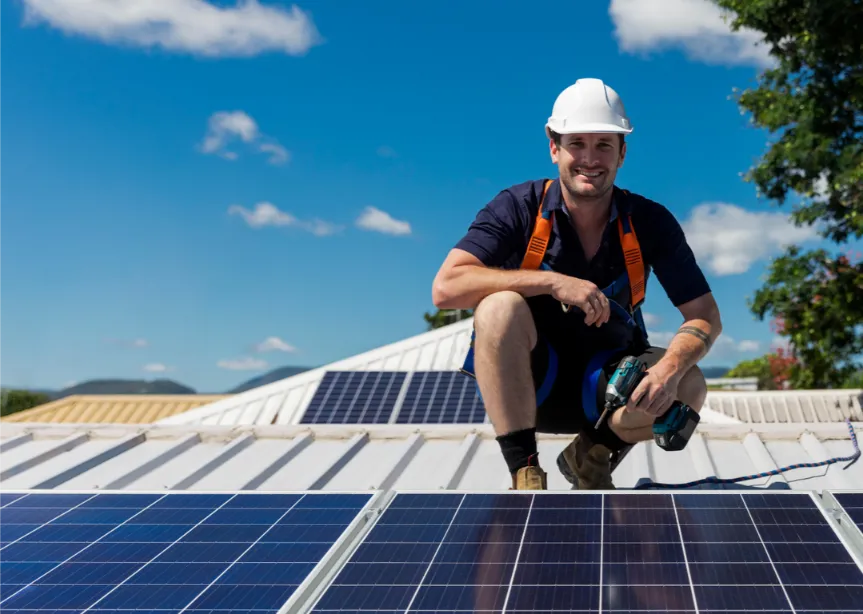 technician on roof installing solar panels